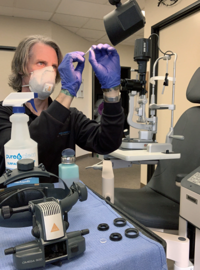 man working with eyecare equipment